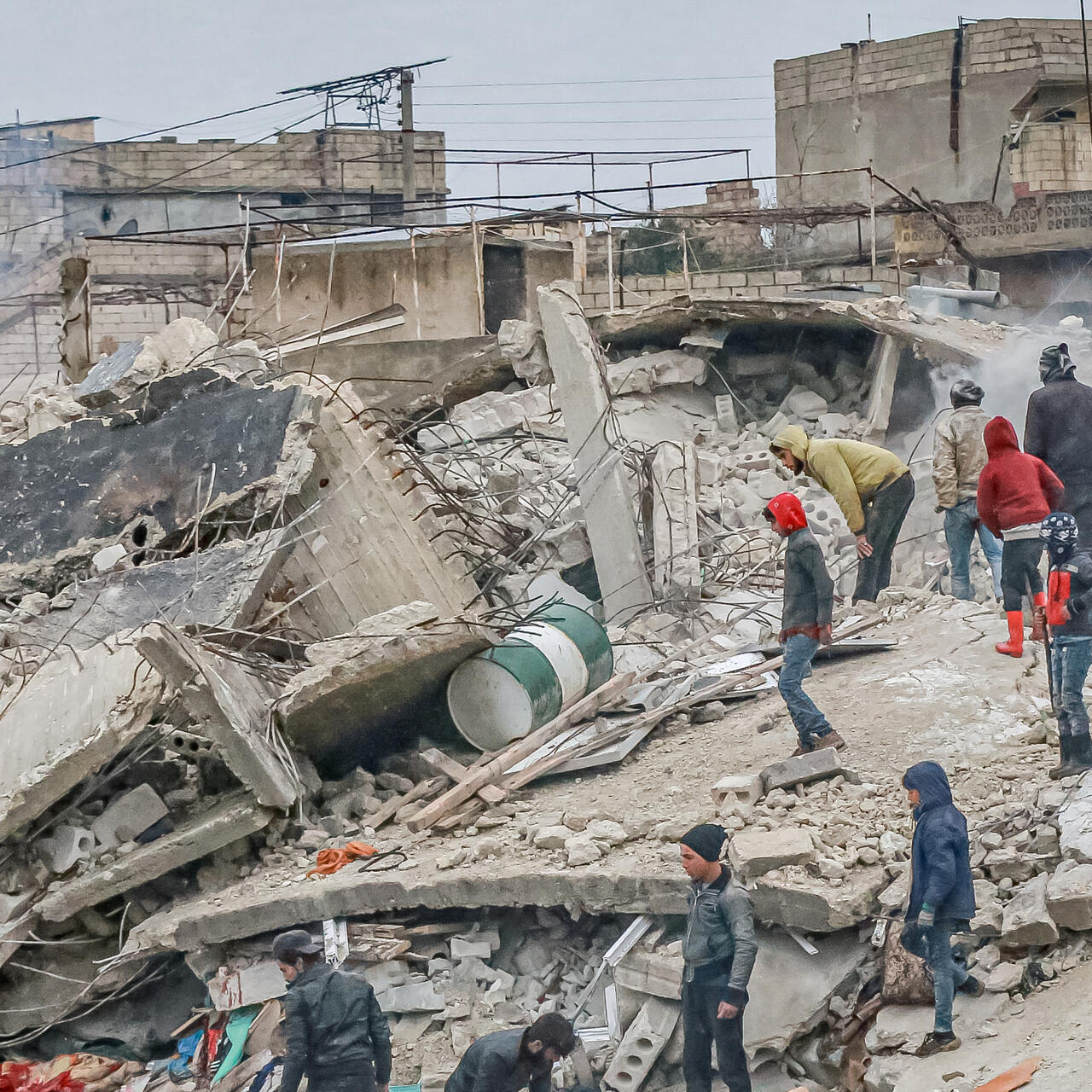 A crowd of medical personnel and civilians conduct search and rescue operations in the remains of destroyed buildings in Syria after the 7.7 earthquake on the morning of February 6, 2023. 